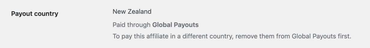 A linha País de pagamento na tela Editar afiliado de um afiliado no AffiliateWP, mostrando Nova Zelândia com a linha Paga através de Pagamentos Globais abaixo dela